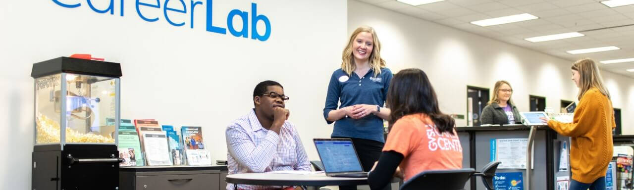 Staff assisting student at career lab